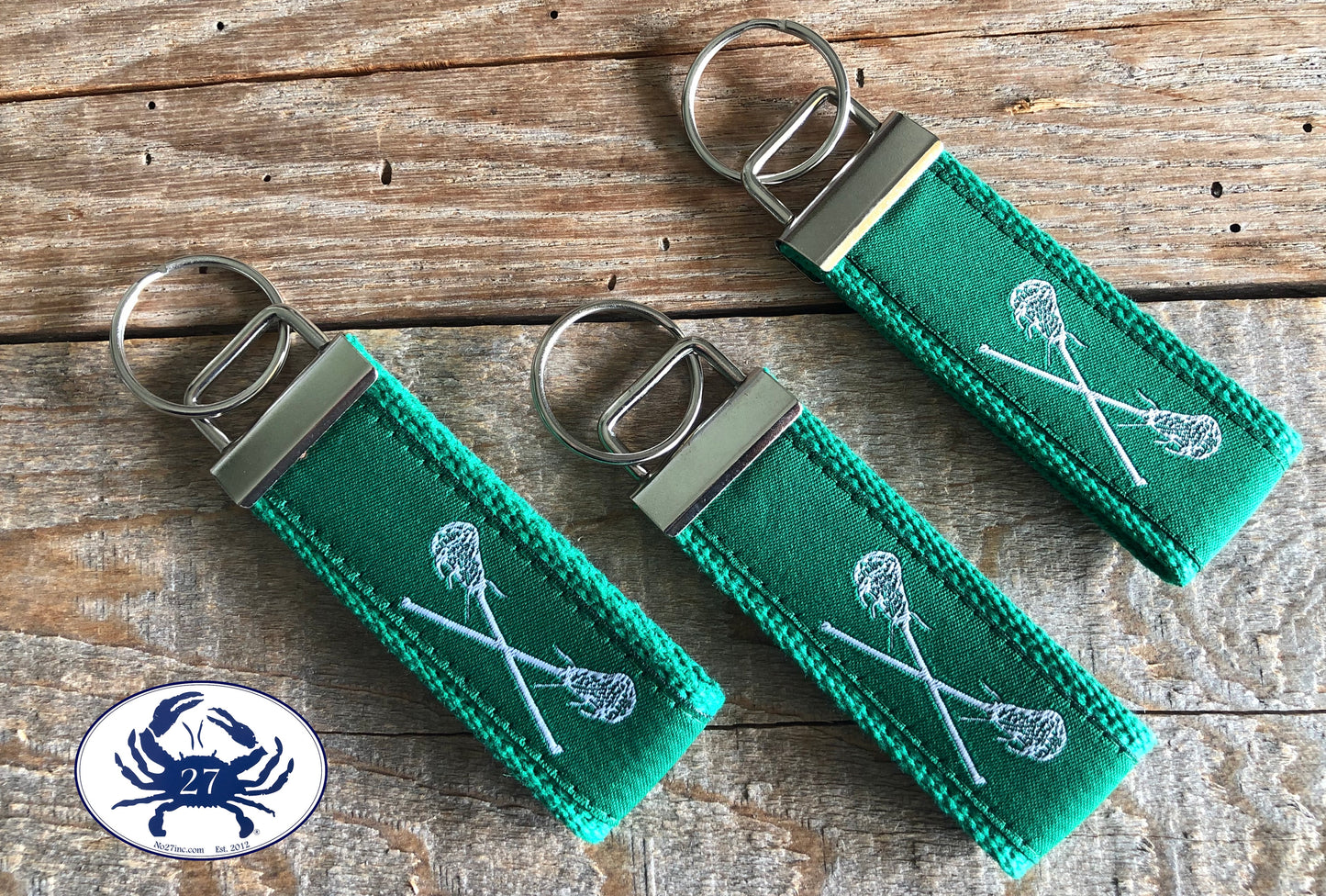 White Lacrosse Sticks on Green Key Chain