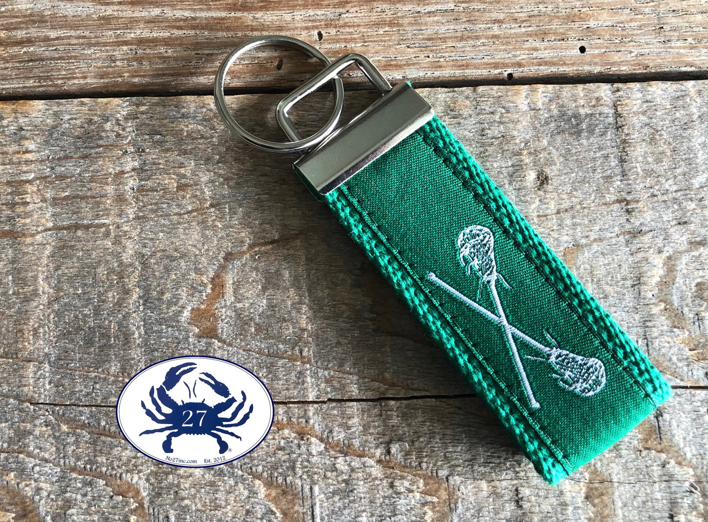 White Lacrosse Sticks on Green Key Chain