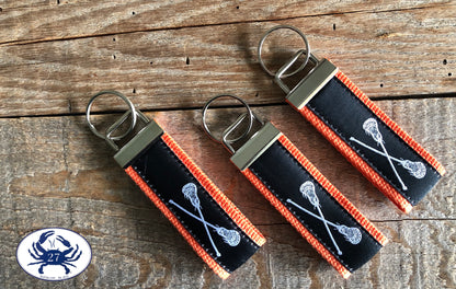 White Lacrosse Sticks on Black Key Chain