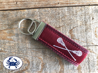 White Lacrosse Sticks on Maroon Key Chain