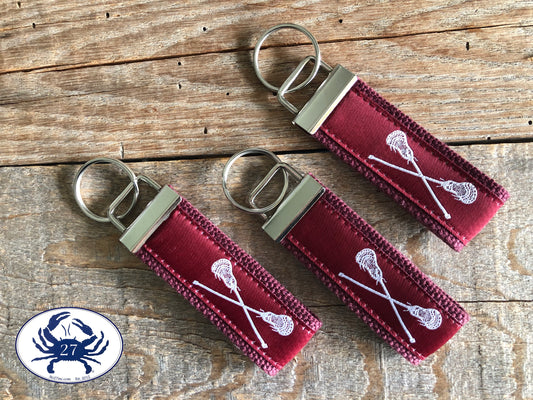 White Lacrosse Sticks on Maroon Key Chain