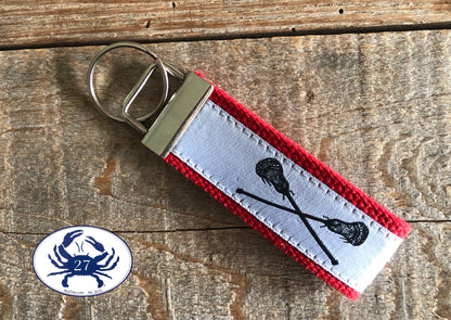 Black Lacrosse Sticks on White Key Chain