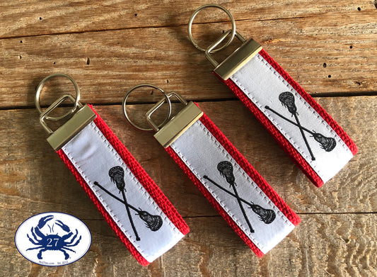 Black Lacrosse Sticks on White Key Chain