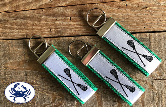 Black Lacrosse Sticks on White Key Chain