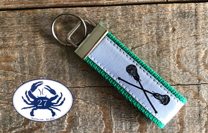 Black Lacrosse Sticks on White Key Chain