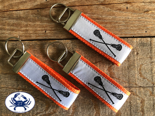 Black Lacrosse Sticks on White Key Chain