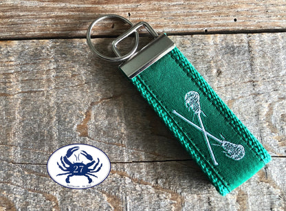 White Lacrosse Sticks on Green Key Chain
